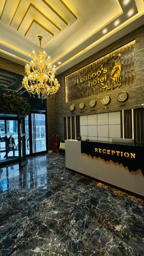 a hotel lobby with a chandelier and a reception desk at El Baboos Hotel in Bostaniçi