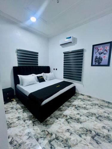 a bedroom with a large bed in a room at Havmoorehomes Ltd in Port Harcourt