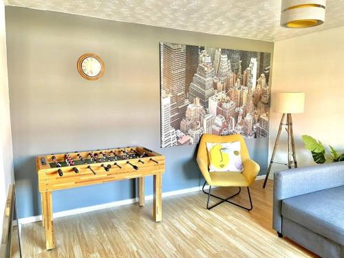 a room with a chess board and a chair and a clock at 20% Monthly stays - 3 bedrooms @ Homevy Leeds in Beeston Hill