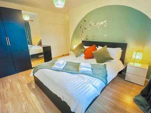 a bedroom with a large bed with towels on it at 20% Monthly stays - 3 bedrooms @ Homevy Leeds in Beeston Hill