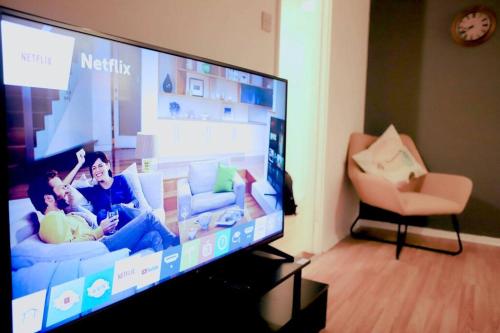 uma televisão de ecrã plano numa sala de estar em 20% Monthly stays - 3 bedrooms @ Homevy Leeds em Beeston Hill