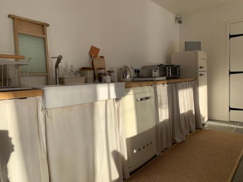 a kitchen with a sink and a counter top at Guest Homes - The Potting Shed in Worcester