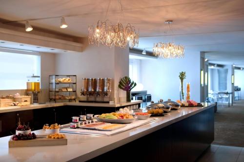 a kitchen with a counter with many plates of food at Toronto Marriott City Centre Hotel in Toronto