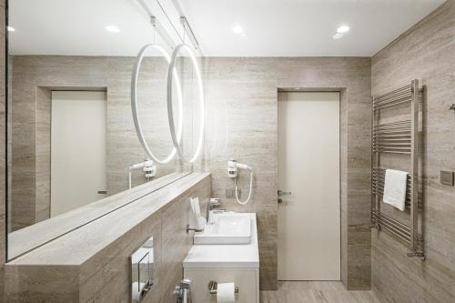 a bathroom with a sink and a mirror at Tavel Hotel & SPA in Bukovel