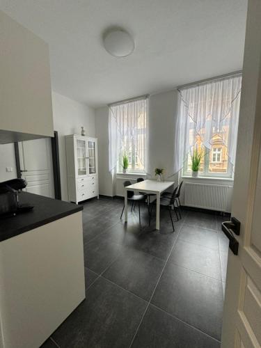 a kitchen with a table and a table and chairs in a room at Top class apartments in Carlsbad Bulharska street in Karlovy Vary