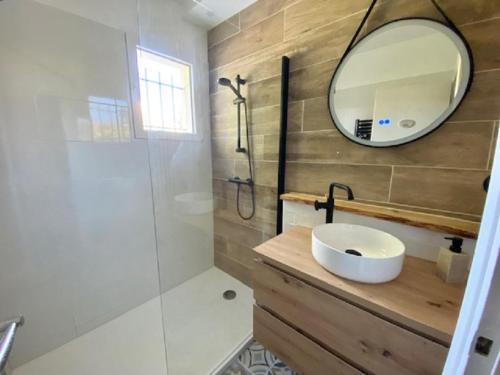 uma casa de banho com um lavatório e um espelho em maison 4 personnes a Sion sur L ocean em Les Bussolleries