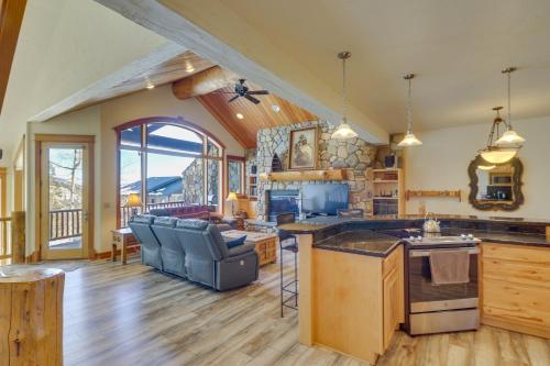 a kitchen and living room with a couch and a table at Spacious Whitefish Home with Sauna and Ski Resort View in Whitefish