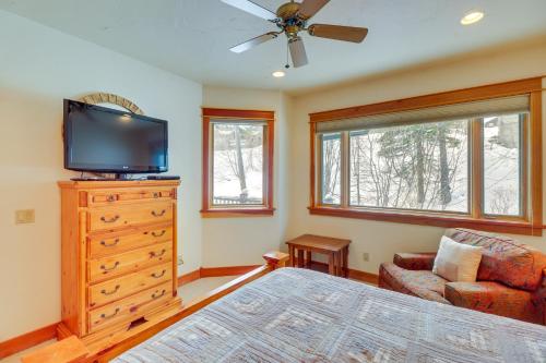 a bedroom with a bed and a tv and a dresser at Spacious Whitefish Home with Sauna and Ski Resort View in Whitefish