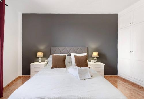 a bedroom with a large white bed with two night stands at La Tablada Atlantic View in Adeje