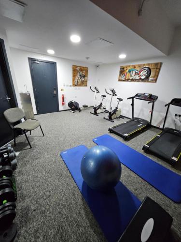 a gym with several exercise bikes and a ball on the floor at Trivelles Regency, Nottingham in Nottingham