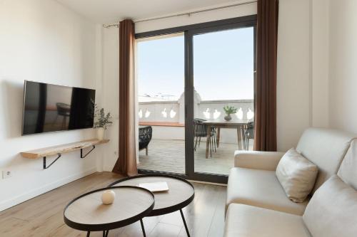 a living room with a couch and a table at Ola Living Calabria in Barcelona