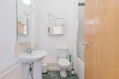 Baño blanco con aseo y lavamanos en The Mayor Suite - IFSC Dublin 1, en Dublín