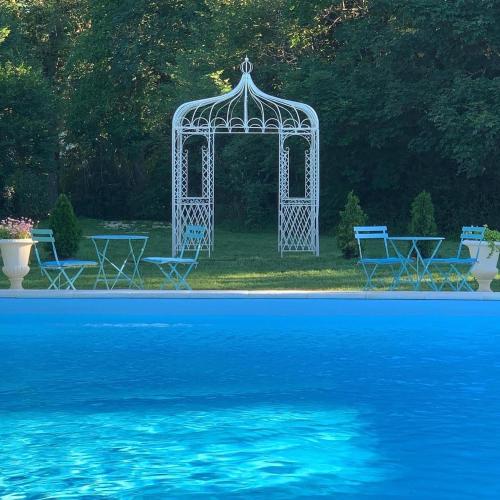 - un kiosque et des chaises à côté de la piscine dans l'établissement The Stables Gite at Chateau Mas de Pradié, à Foissac