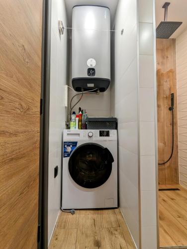 a washer and dryer in a tiny house at Pine & Wine Sauna Apartment in Pamporovo