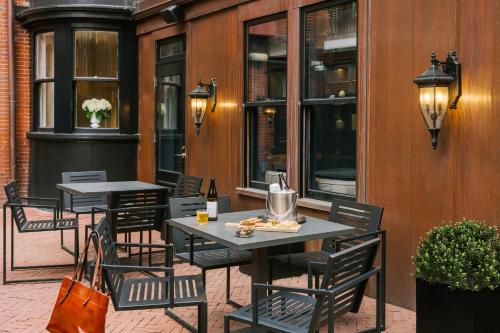two tables and chairs sitting on a patio at No. 284 powered by Sonder in Boston
