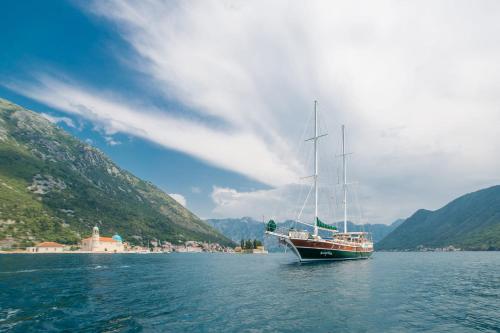a boat floating on a large body of water at Traditional Sailing Yacht in Tivat