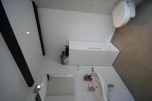 a small white bathroom with a sink and a tub at Ferienwohnung für vier Personen - b57603 in Lütow