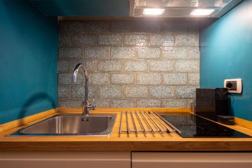 a kitchen with a sink and a counter top at Ardiglione Flat in Florence