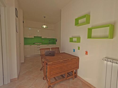 a kitchen with a wooden table with a laptop on it at Hotel Villa Argentina in Riomaggiore