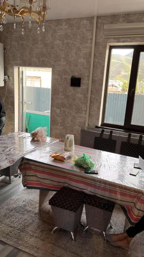 a table in a kitchen with a counter top at Дастан гостевой дом in Naryn