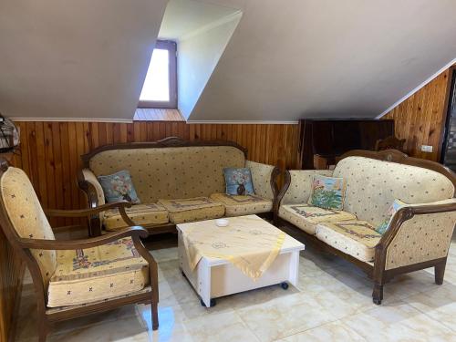 a living room with a couch and chairs and a table at Homestay in Batumi Дом в Чакви in Chakvi