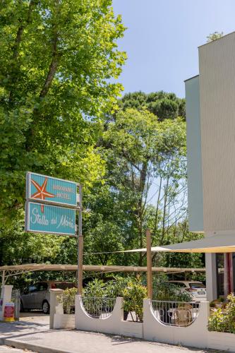 a street sign in front of a building at Hotel Stella Del Mare in Cervia