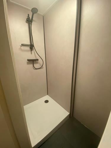 a walk in shower with a shower head and a shower at Next To Sea in Vlissingen