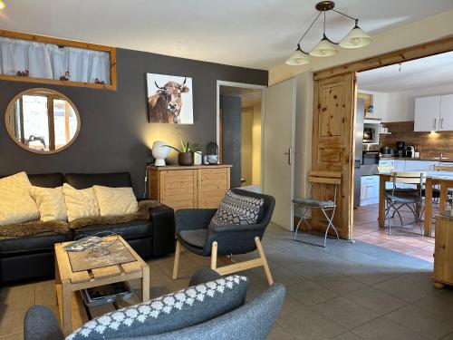 a living room with a couch and chairs and a kitchen at Chalet Barmaz in Val-d'Isère