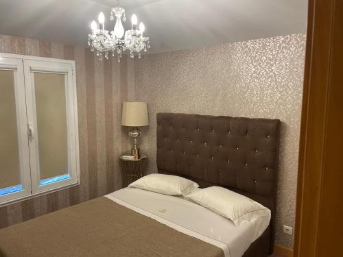 a bedroom with a bed and a chandelier at Casas do Picoutinho in Ponte de Lima