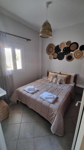 a bedroom with a large bed with towels on it at Voulitsa's Apartment in Kanali