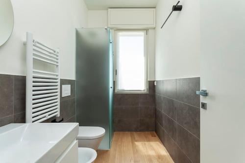a bathroom with a toilet and a glass shower at art of design & terrace in Milan