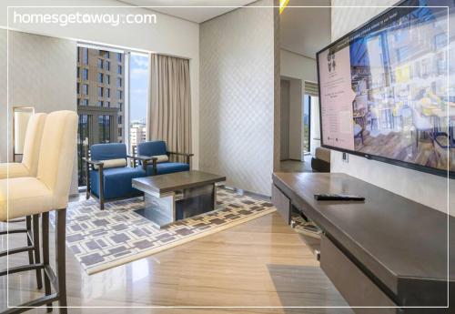 a waiting room with a large screen in a hotel room at Cozy 1BR Hyatt Creek Heights Residences in Dubai