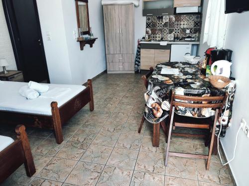 una camera con tavolo e una cucina con letto di Orantes Maris Luxury a Katápola