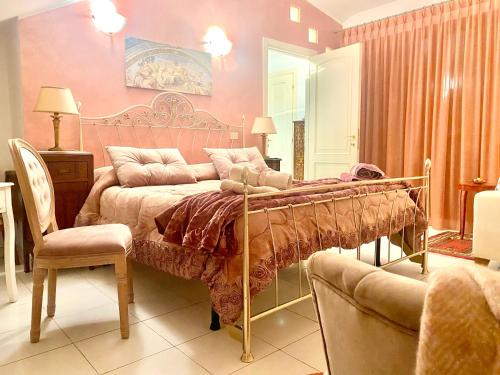 a bedroom with a bed and a chair at CasAzzurra in Ortona