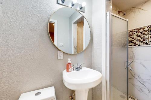 a bathroom with a sink and a mirror at Houston Hideaway - Unit C in Houston