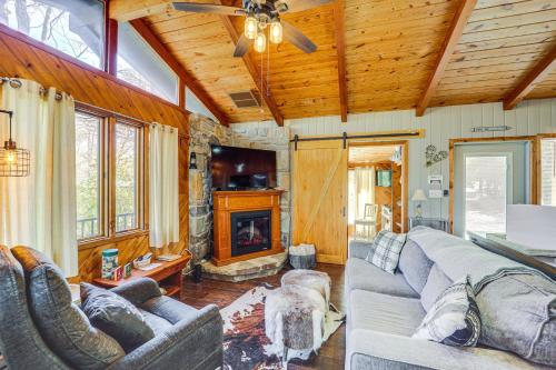 a living room with a couch and a fireplace at Near Lake and Trails Rustic Newland Cabin with Deck! in Newland