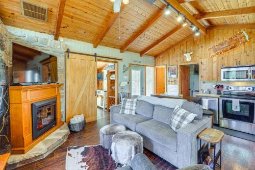 a living room with a couch and a fireplace at Near Lake and Trails Rustic Newland Cabin with Deck! in Newland