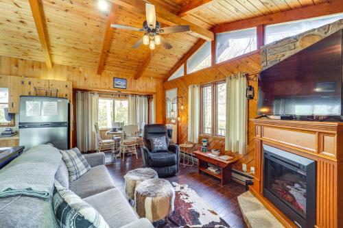 a living room with a couch and a fireplace at Near Lake and Trails Rustic Newland Cabin with Deck! in Newland