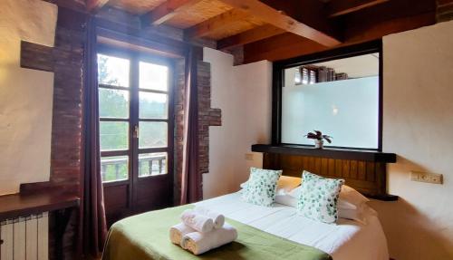 a bedroom with a bed with a large window at Casa Florenta in Las Rozas