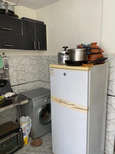 a kitchen with a refrigerator and a pot on top of it at Jolie appartement oulfa azhar in Casablanca