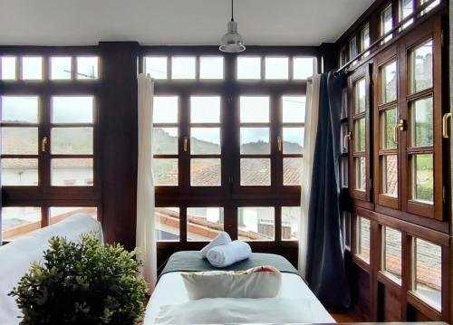 a room with windows and a bed with a pillow at Casa Florenta in Las Rozas