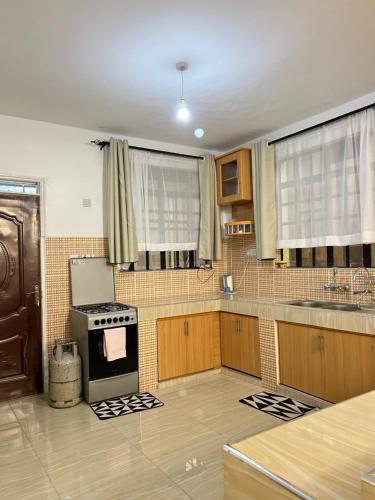 a kitchen with a stove and a sink in it at The comfortplace Naivasha in Naivasha