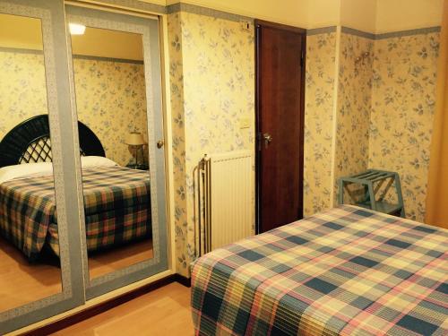 Säng eller sängar i ett rum på Hotel Biondi