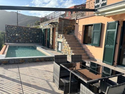 a house with a swimming pool on a patio at Villa Nina in Moneglia
