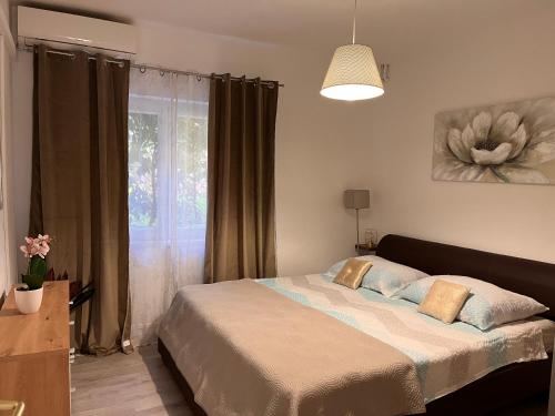 a bedroom with a bed and a window at Apartments Villa Mirella 20 m from the sea - free parking in Trogir