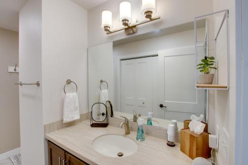 a bathroom with a sink and a large mirror at Riverfront Sheboygan Townhome with Grill! in Sheboygan