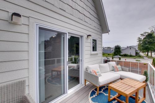 a patio with a couch and a table on a porch at Riverfront Sheboygan Townhome with Grill! in Sheboygan