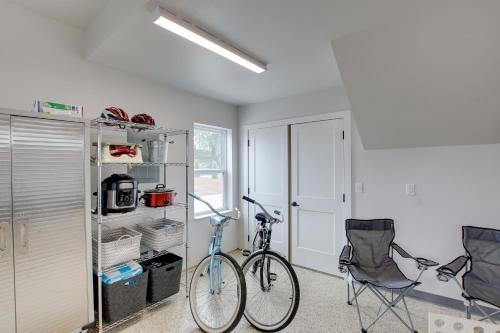 a bike parked in a room with two chairs at Riverfront Sheboygan Townhome with Grill! in Sheboygan