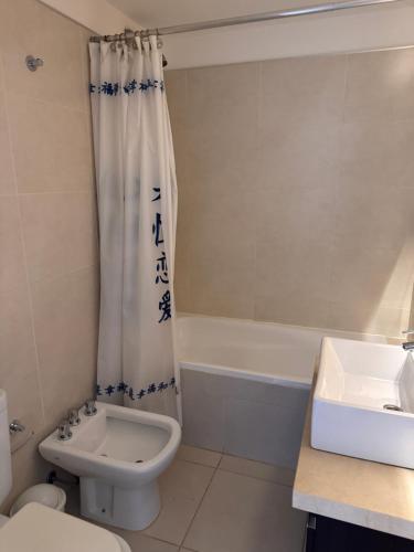 a bathroom with a sink and a toilet and a tub at Río Grande Buena Vista in Río Grande