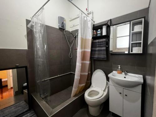 a bathroom with a toilet and a shower and a sink at Terrace Plaza Historic in Lima